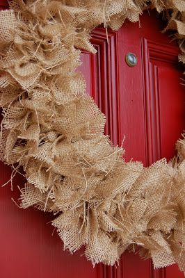 a burlock wreath on a red door