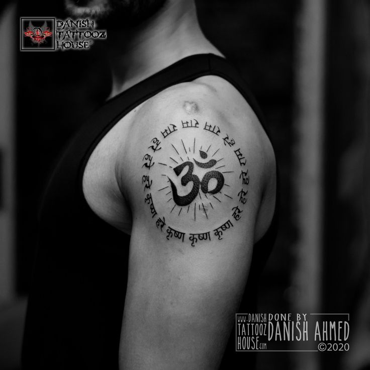 a man with a tattoo on his arm that has an om shant in it