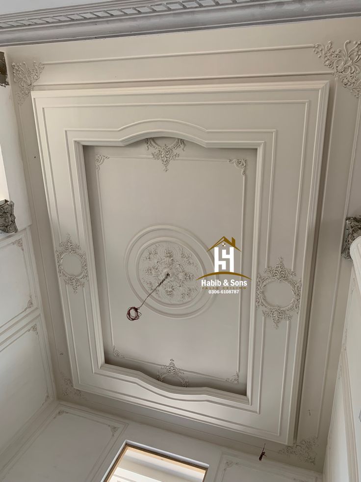 the ceiling is painted white and has a clock on it