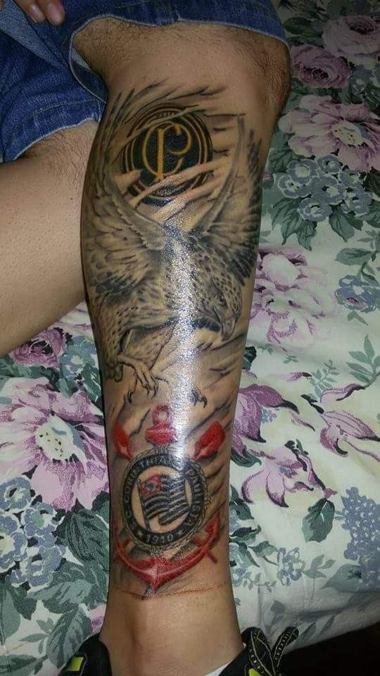 a man's leg with tattoos on it and an eagle sitting in the middle