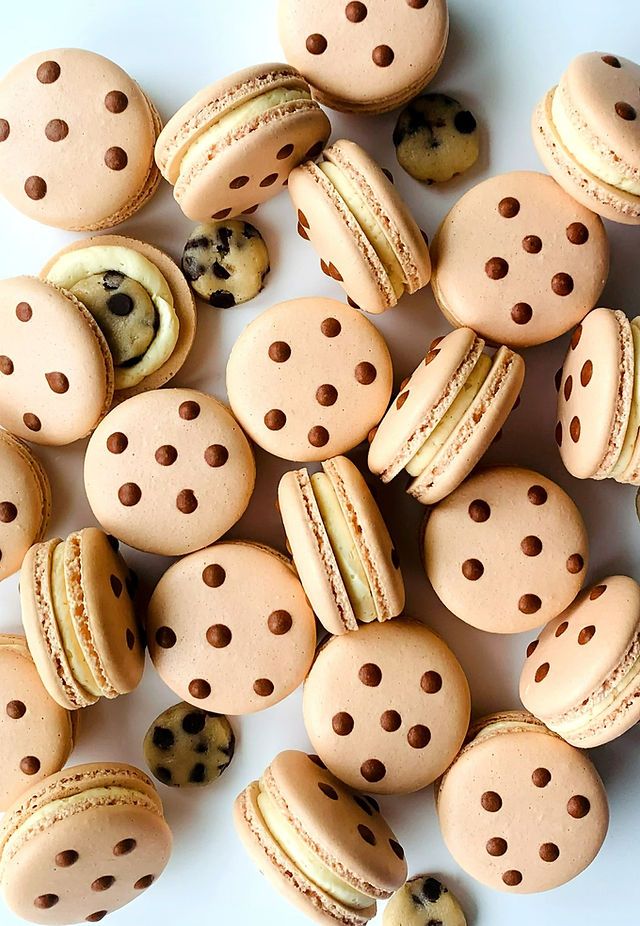 macaroni and chocolate chip cookies are arranged on a white surface with holes in the middle