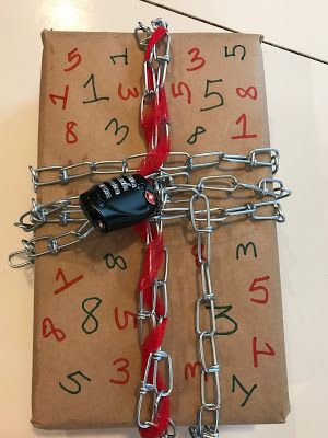 a gift wrapped in paper with chains and padlocks attached to it