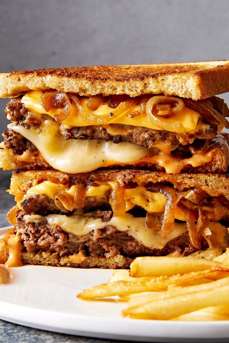 a grilled cheeseburger with french fries on the side is ready to be eaten