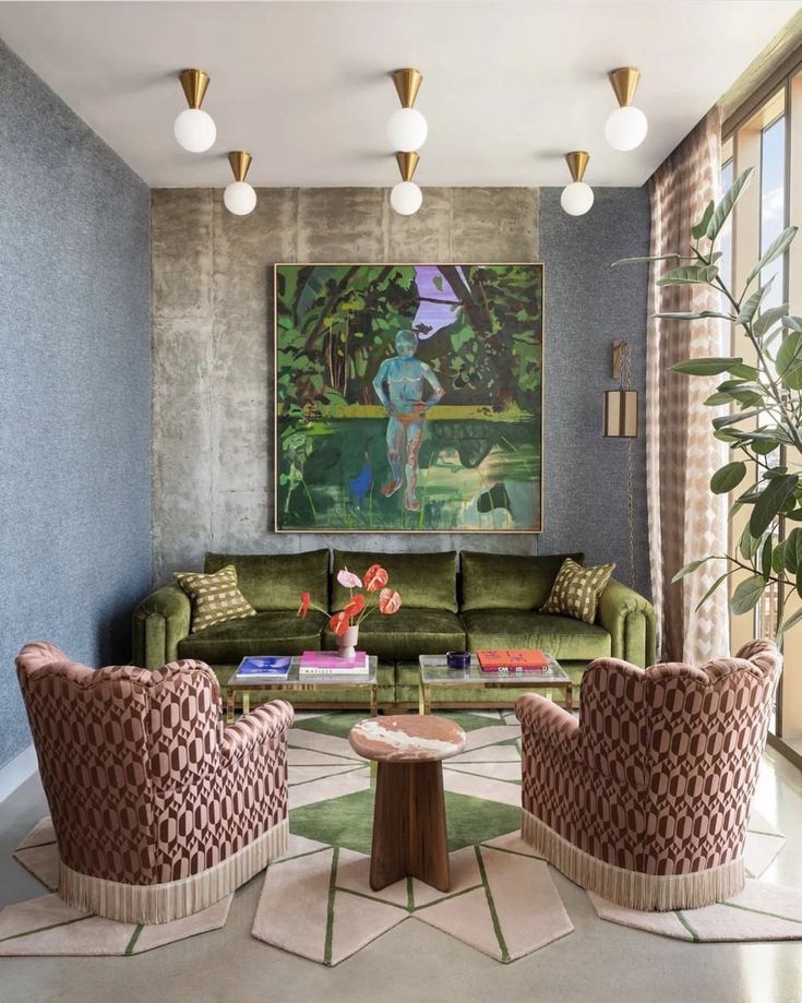 a living room filled with green couches and chairs next to a painting on the wall