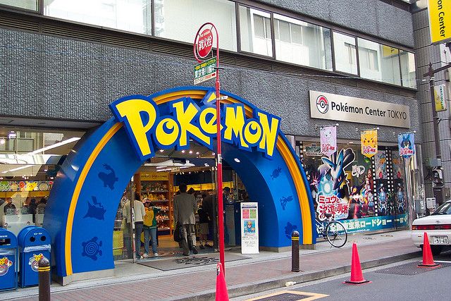 an entrance to a pokemon store on a city street