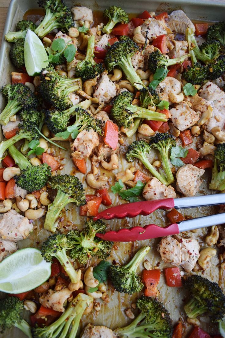 a tray filled with chicken, broccoli and carrots