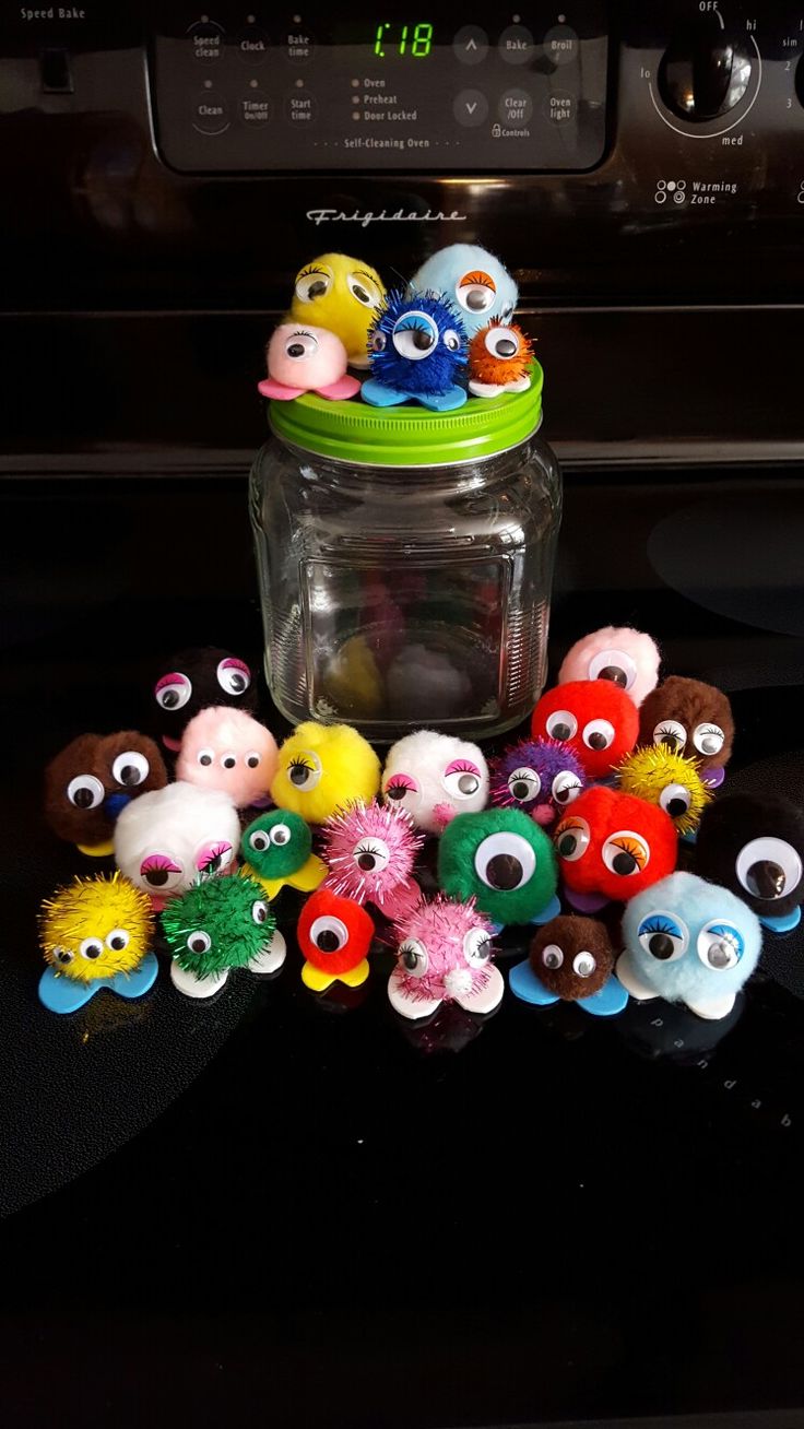 a jar filled with lots of different colored stuffed animals