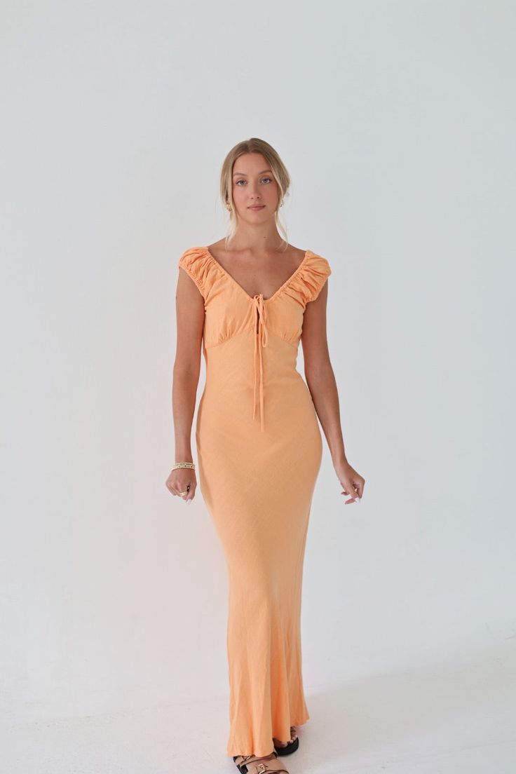 Turn heads at your next dinner party with our Summer Dinner Party Dress. This orange linen maxi dress is both fun and colorful, making you the life of the party. Sleeveless Apricot Maxi Dress For Party, Apricot Maxi Party Dress, Summer Party Apricot Maxi Dress, Apricot Fitted Maxi Dress For Party, Elegant Apricot Maxi Dress For Party, Fitted Apricot Maxi Dress For Party, Sleeveless Orange Maxi Dress For Garden Party, Apricot Maxi Dress For Party, Elegant Fitted Midi Dress For Summer Parties