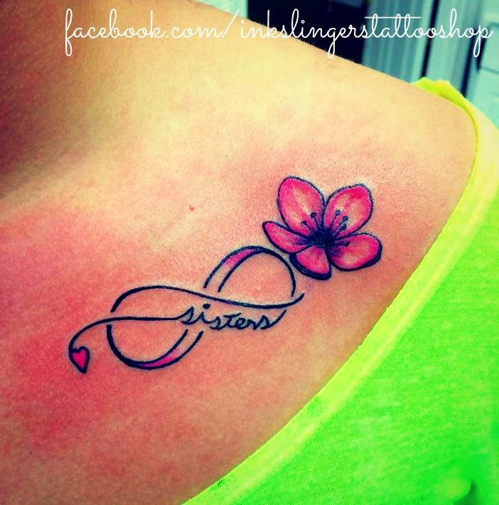 a woman with a tattoo on her shoulder and the word vision written in cursive writing