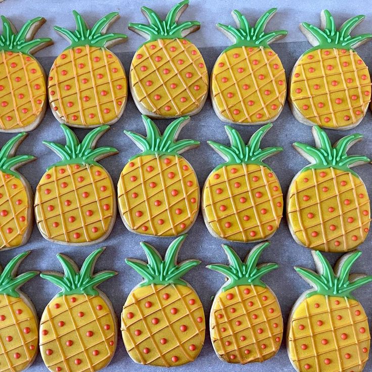 decorated cookies in the shape of pineapples