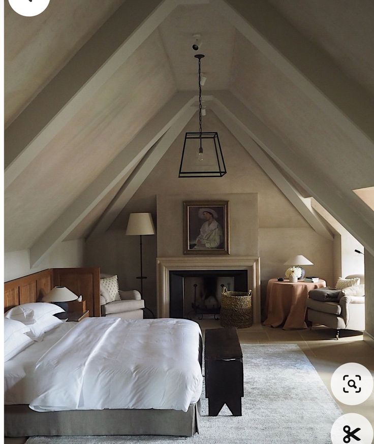 an attic bedroom with a bed and fireplace