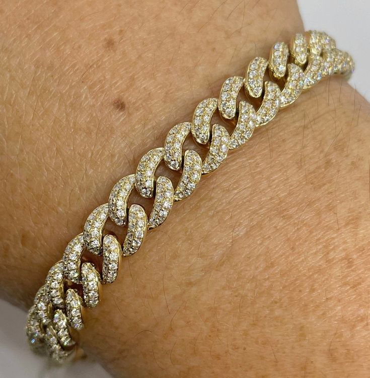 "Beautiful Pave Link Bracelet Yellow Gold set with sparkling diamonds.  Feels nice and solid 22.72 grams of solid gold.  The back of the bracelet is smooth shiny gold. This bracelet is like a buy one get one free.  Lol. You can wear the diamond side or flip the bracelet over and wear on the plain gold side on more casual days.  Measures 8mm width.  The lock is nice and secure with safety latch.  The diamonds are set nice and smooth.  Excellent craftsmanship.  7\" length.   Genuine earth mined round brilliant cut diamonds  Total weight: 3.85 Carats Clarity: SI/ I Color: G All shiny diamonds, no cloudy or yellowish stones  Solid 14K Gold 22.72 grams  Comes with gift box * We have been in the wholesale Jewelry business for over 30 years serving the community at the same location.  All diamond Diamond Chain Bracelet, Serving The Community, Cuban Link Bracelet, Bracelet Diamond, Link Chain Bracelet, Buy One Get One Free, Yellow Gold Setting, Diamond Chain, Cuban Link Chain