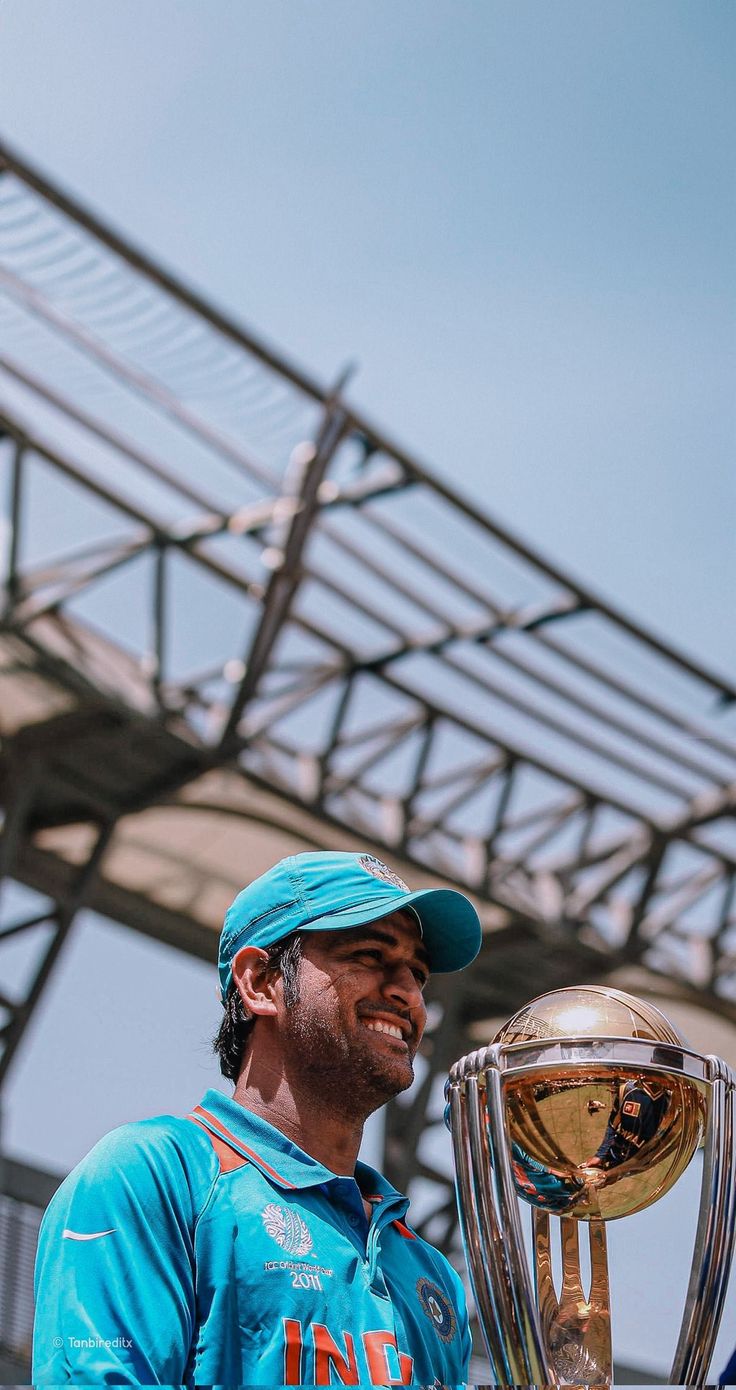 a man in blue shirt holding up a trophy