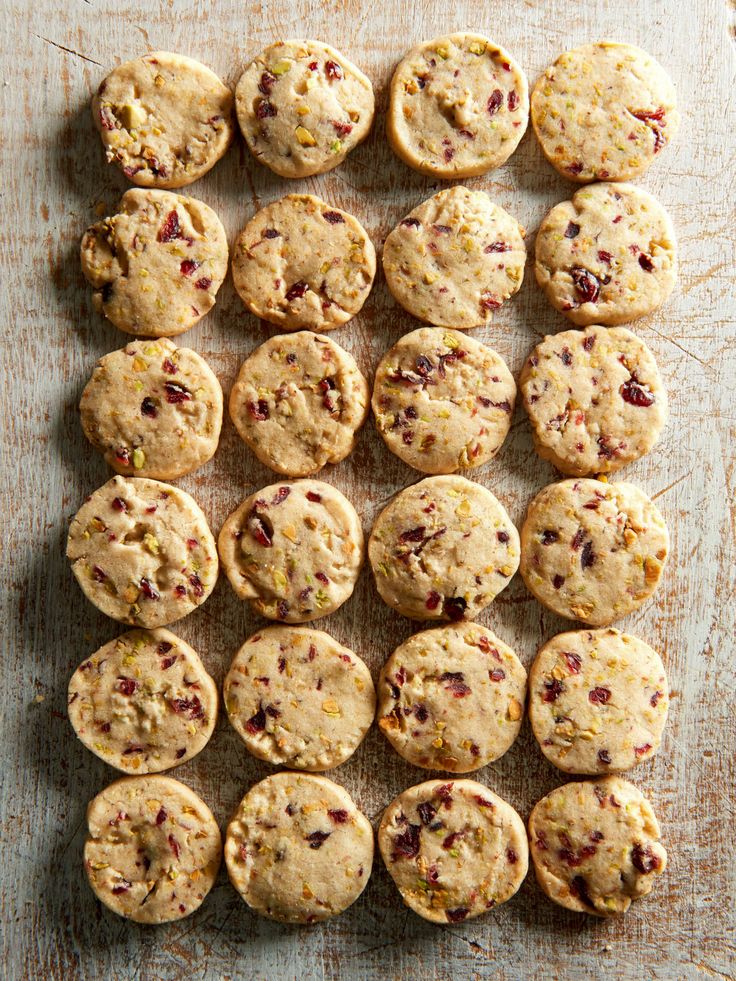 a wooden table topped with lots of cookies