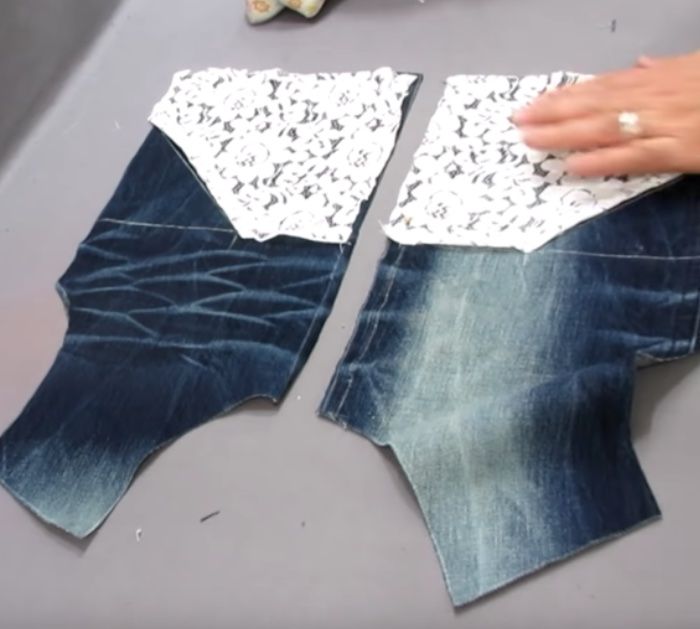 two pieces of denim with lace on them being sewn together by someone's hands