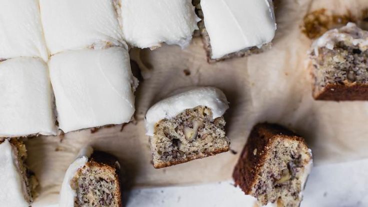 several pieces of cake sitting on top of a cutting board