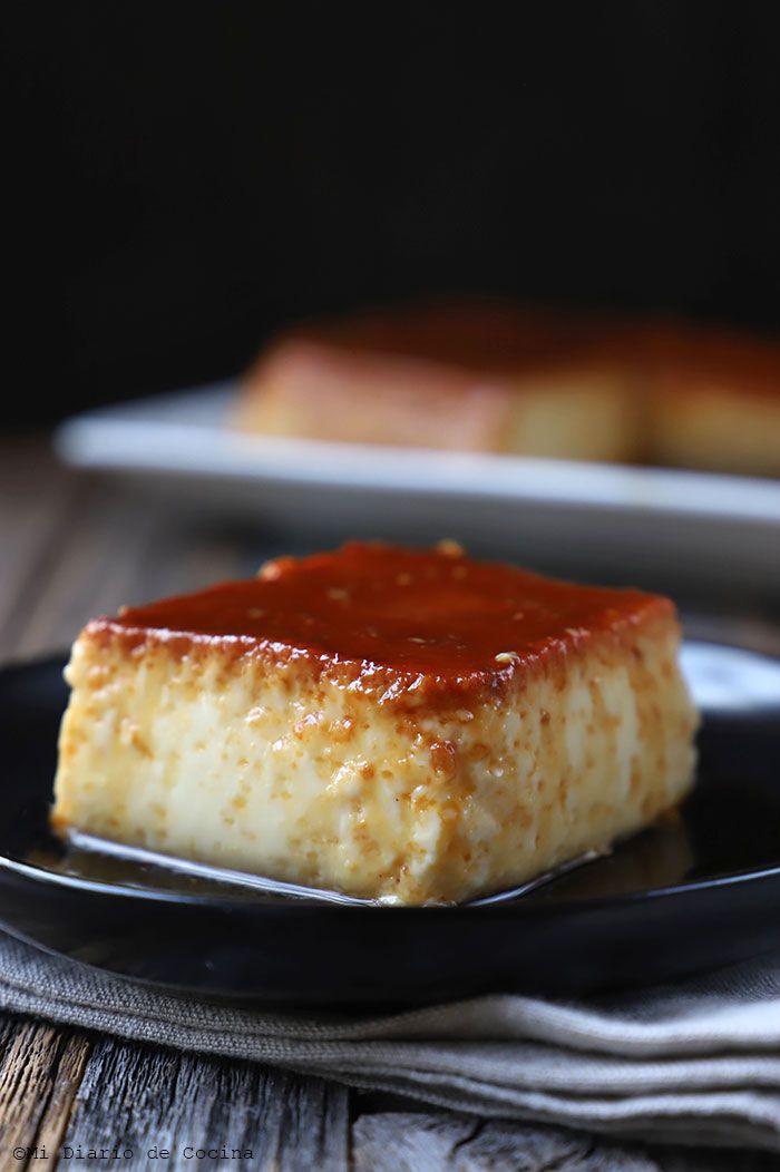 a piece of cheesecake on a black plate