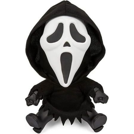 a black and white stuffed animal wearing a ghost costume