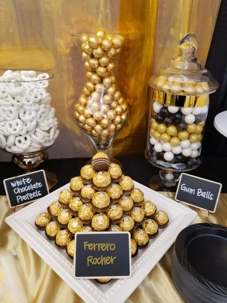 a dessert table with chocolates and candies on it