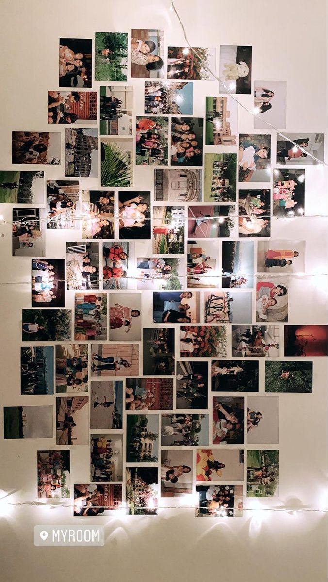 a collage of photos hanging on the wall with lights around it and below them