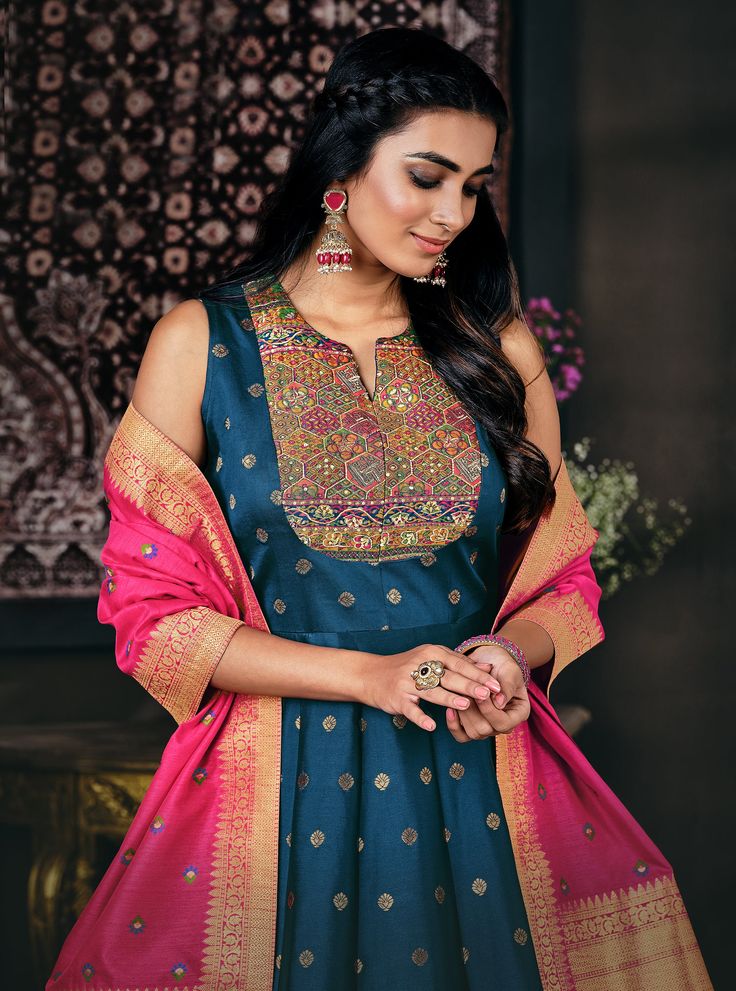 COLOR : Blue & Pink FABRIC : Jacquard Banarasi Silk WORK : Woven Zari & Thread Work, Resham Embroidery (around neckline), Tassels (on dupatta), Lace Border OCCASION : Wedding, Reception, Festival, Party Wear, Sangeet READY-TO-WEAR : NoSTITCHING : Available as semi-stitched fabric, can be stitched using standard size option (+$20). Note: There might be a slight color variation due to lighting and flash used during photoshoot. The bright shade seen is the best closer view of fabric's color. Traditional Blue Sleeveless Anarkali Set, Traditional Sleeveless Anarkali Set With Cutdana, Eid Anarkali Dress In Slub Silk, Anarkali Slub Silk Dress For Eid, Blue Anarkali Set With Pallu, Blue Anarkali Set With Pallu And Straight Kurta, Blue Anarkali Set With Straight Kurta And Pallu, Blue Sleeveless Traditional Wear For Festive Occasions, Festive Sleeveless Blue Traditional Wear