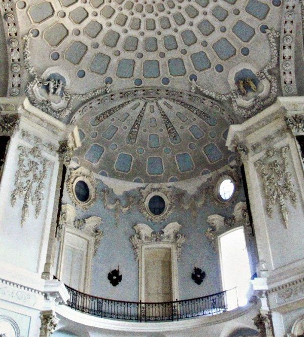 an ornate ceiling in the middle of a building with windows and balconies on each side