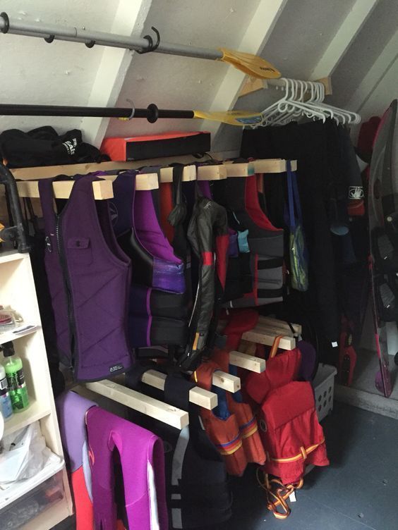 a room filled with lots of different colored bags and backpacks hanging from the ceiling