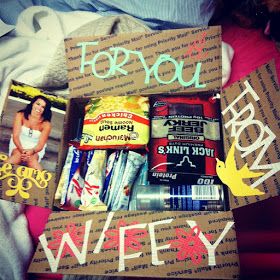 a cardboard box with some food inside of it on top of a bed next to a stuffed animal