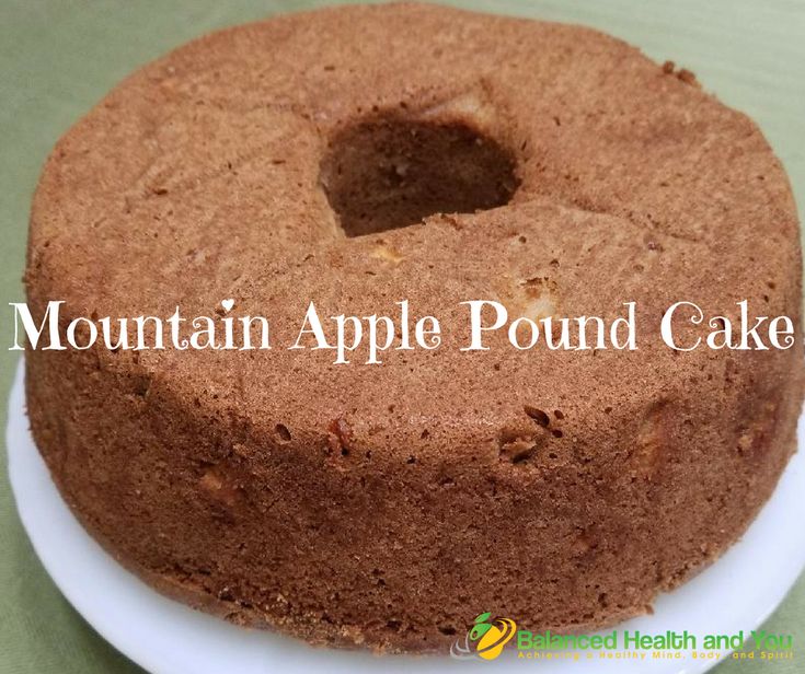 a round cake on a plate with the words mountain apple pound cake in front of it