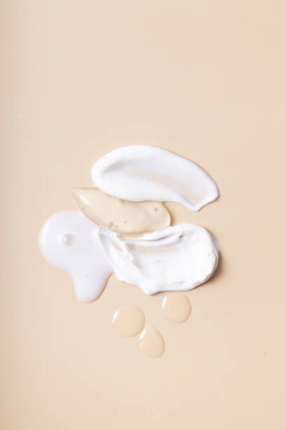 three white objects on a beige surface with drops of water coming out of the top