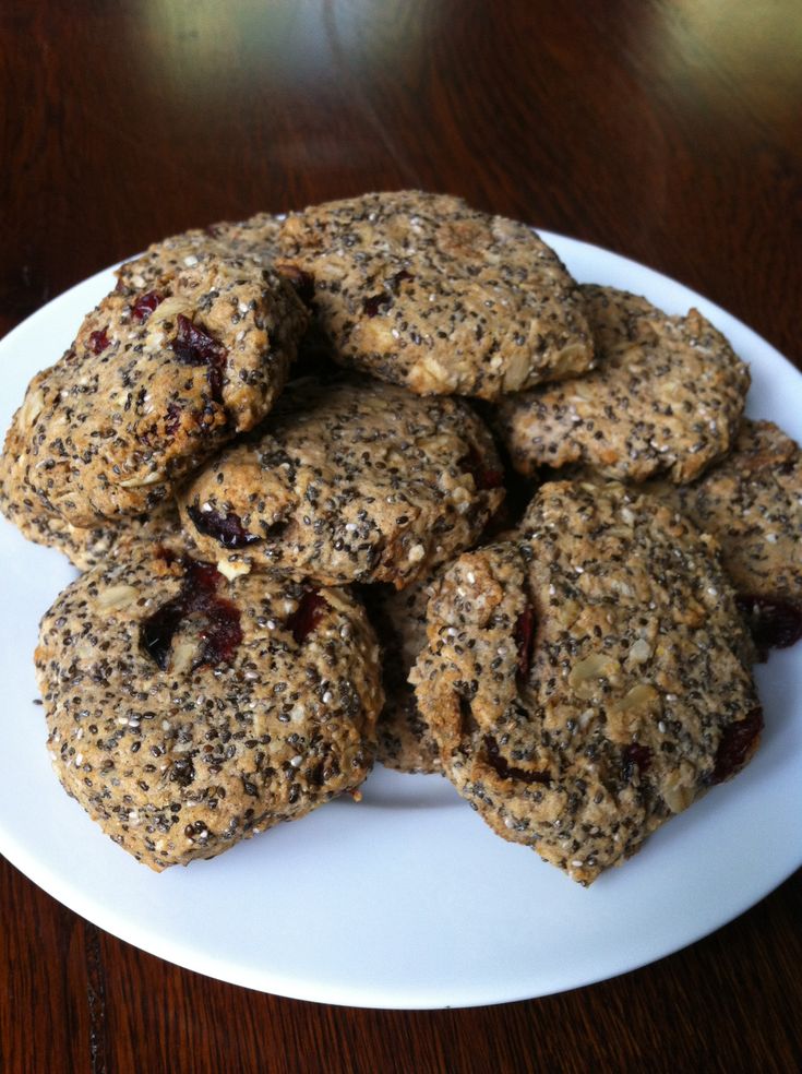 a white plate topped with cookies on top of a wooden table