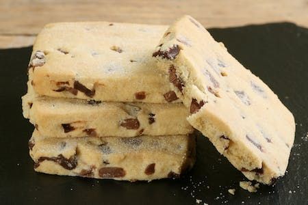 three pieces of chocolate chip cookies stacked on top of each other with one broken in half