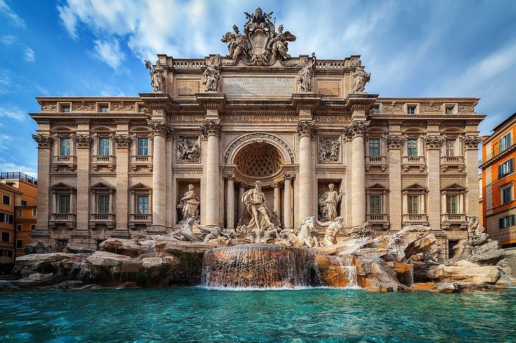 a large building with a fountain in front of it