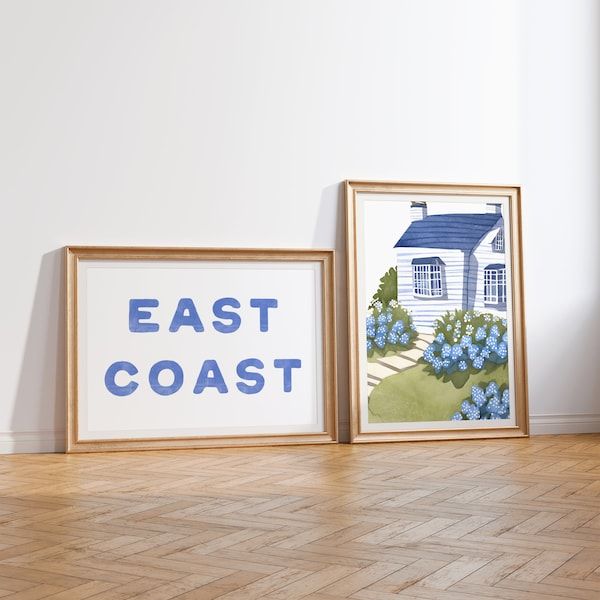 two framed pictures sitting on top of a hard wood floor