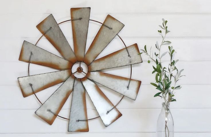 a metal windmill is hanging on the wall