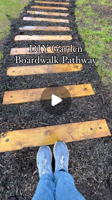 a person standing on a wooden path with the words diy garden boardwalk pathway