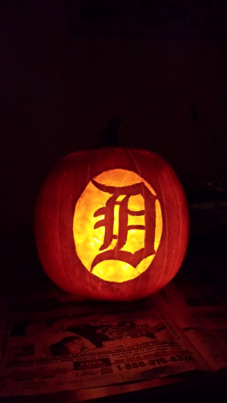 a pumpkin carved to look like a detroit tigers logo with the letter f on it