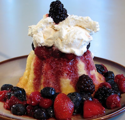 a dessert with berries and whipped cream on top