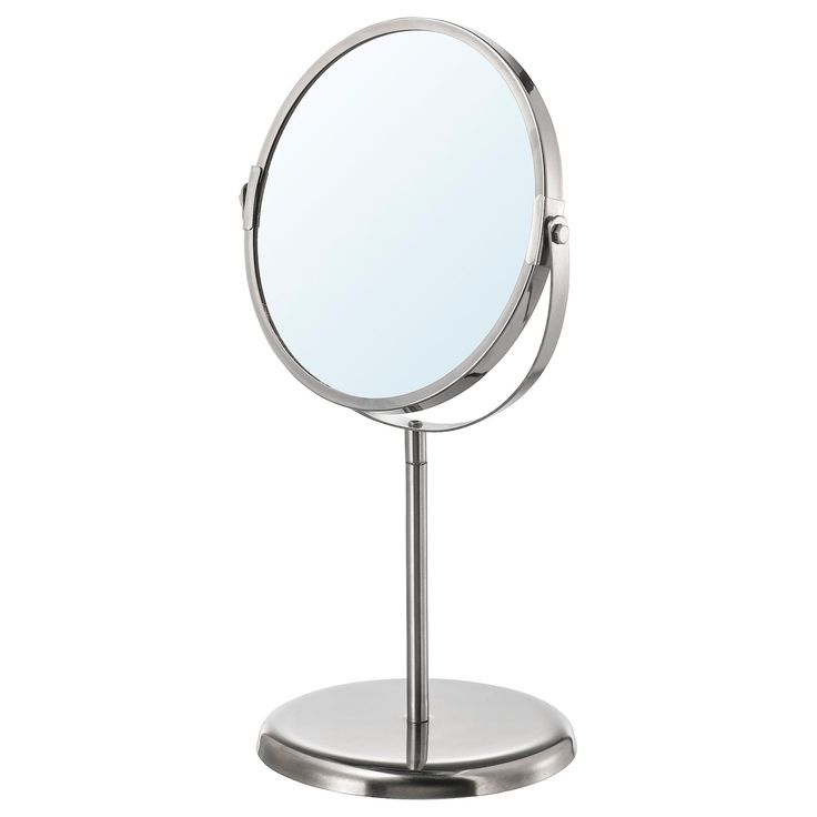 a small round mirror on a metal stand