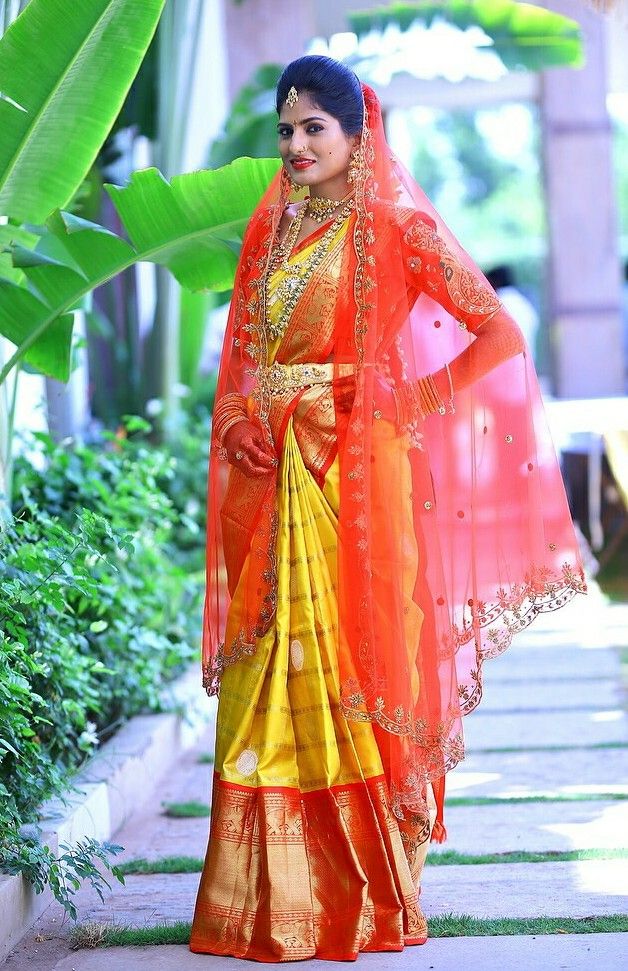 a woman in an orange and yellow sari