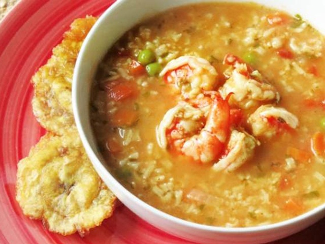 a red plate topped with a bowl of soup