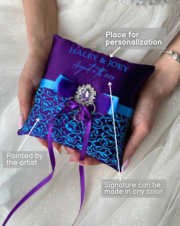 a purple and blue wedding ring pillow with instructions on how to put it in the bag