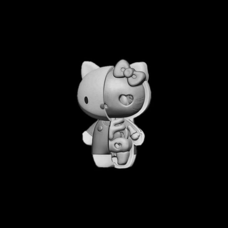 a hello kitty figurine on a black background