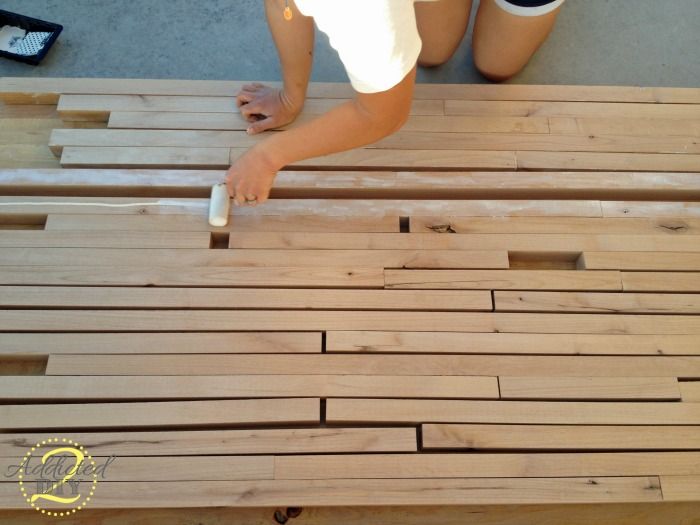 a person is working on some wood planks