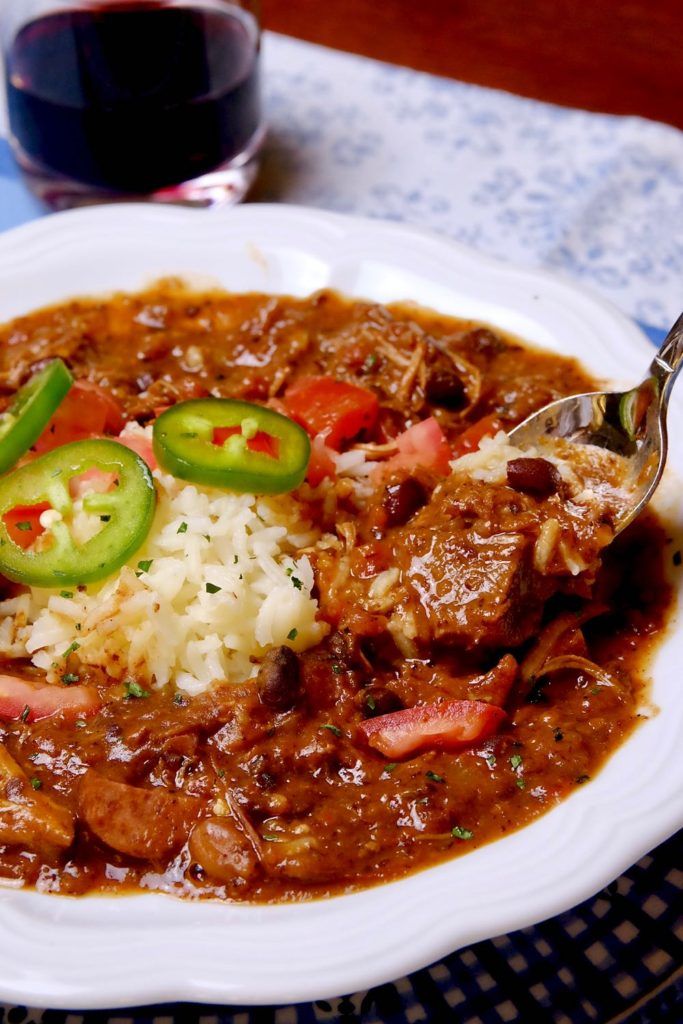 a white plate topped with meat and rice