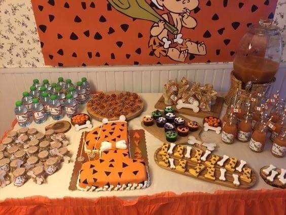 a table topped with lots of desserts and cupcakes