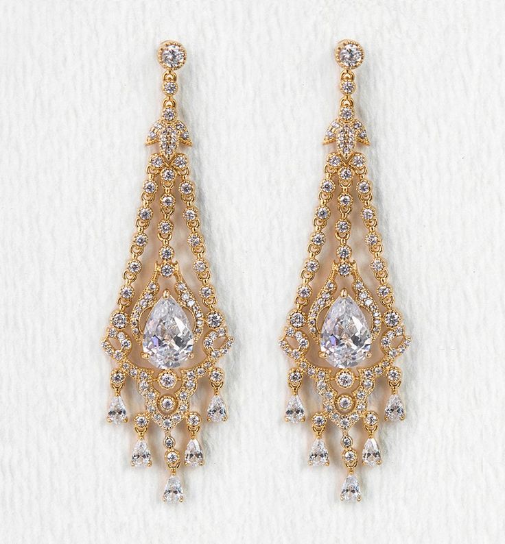 description Dangling cubic zirconia crystals shimmer and sway in these dramatic pavé chandelier earrings. Add these earrings to a wavy ponytail for an easy-elegant look. These earrings are medium weight designs, comfortable to wear for a long period of time. end description materials Available in: 18K White Gold / Gold over base metal Cubic Zirconia pave crystals Hypoallergenic post end materials details Height: 3in (7.6m) x Width: 0.9in (2.2cm) end details sku #E152 end sku Small Diamond Pendant, Bridal Jewelry Gold, Bridal Drop Earrings, Brooch Diamond, Deco Chandelier, Bridal Earrings Chandelier, Silver Chandelier Earrings, Gold Chandelier Earrings, Silver Chandelier