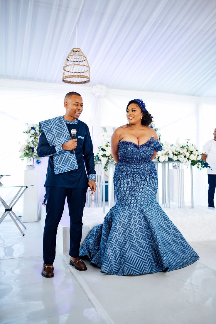 a man and woman dressed in blue standing next to each other