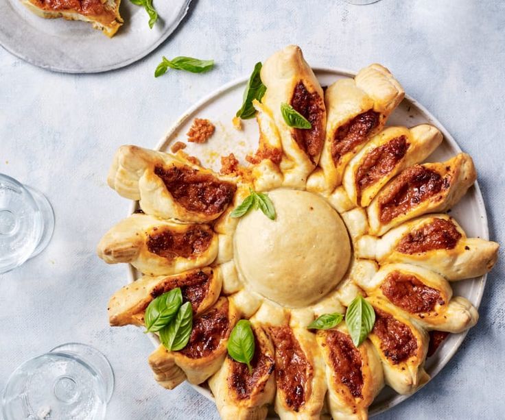 a plate topped with pastries covered in sauce