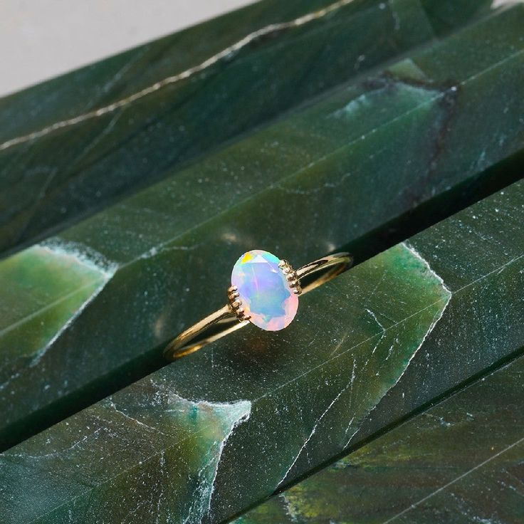 The name opal evolved from the Roman word "opalus" which traces its roots from the Greek's "opallios " meaning to see a change of color. This Greek word is likewise a revision of the ancient Indian Sanskrit's "upala " which means precious stone. The development of this gemstone started millions of years ago when a mixture of silica and water flowed into cracks and holes in the ground. Over time it hardened and solidified to turn into opal.Gemstone :: Ethiopian Opal (Composition - Natural, Enhanc White Gold Drop Earrings, Opal Solitaire Ring, Yellow Gold Drop Earrings, Ethiopian Opal Ring, Gold Promise Rings, Yellow Gold Jewelry, Gold Band Ring, Opal Ring, Minimalist Rings